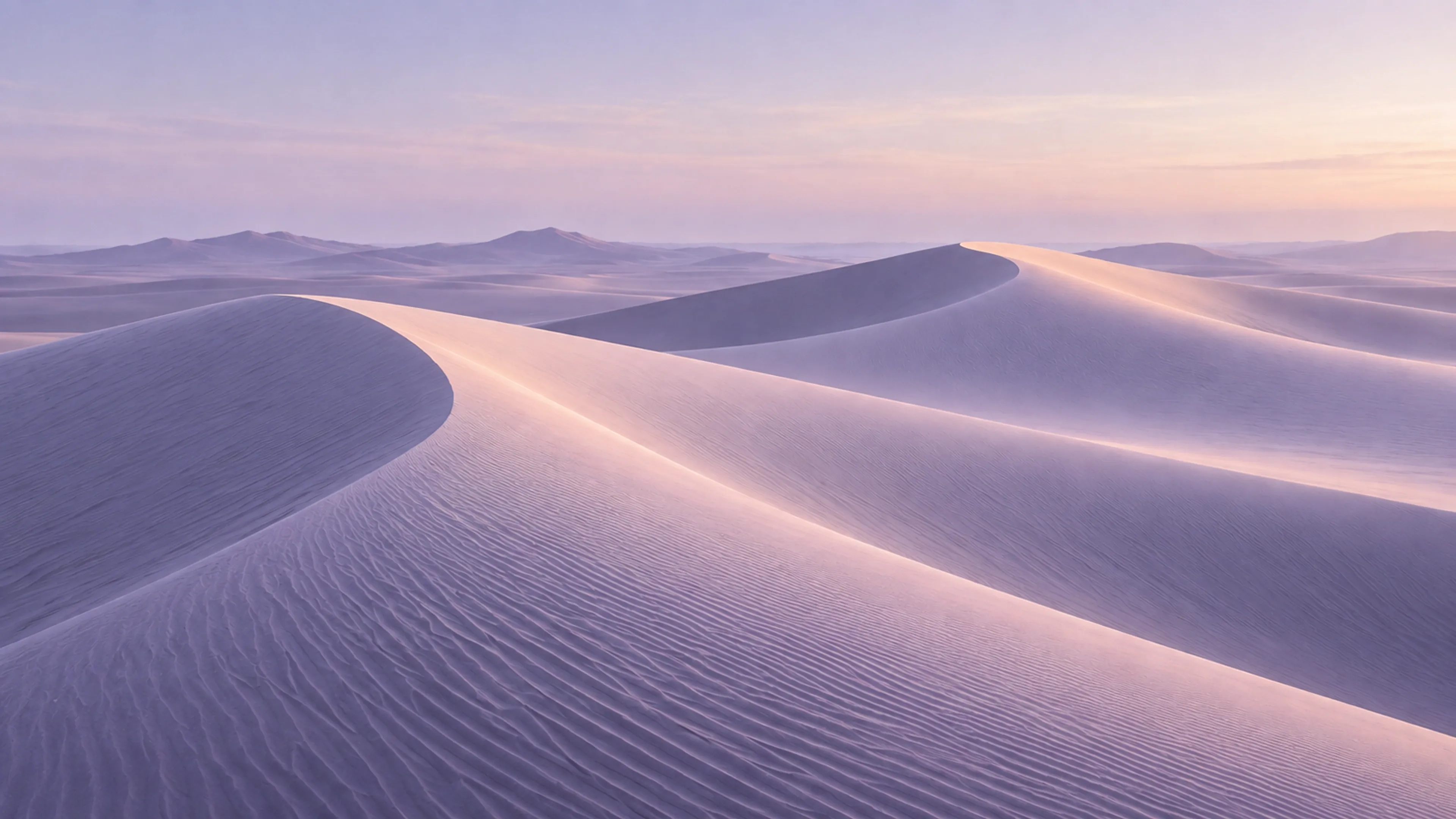 Soft lavender dunes beneath a warm pastel sky