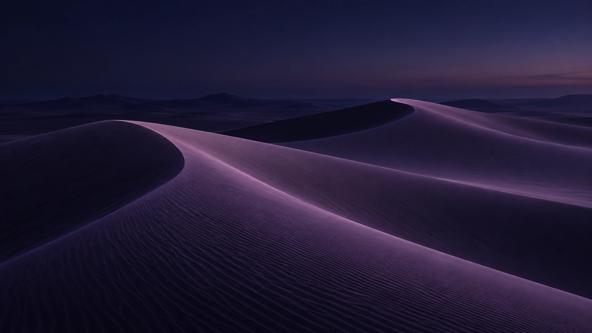 Soft violet sand ridges beneath a calm open horizon